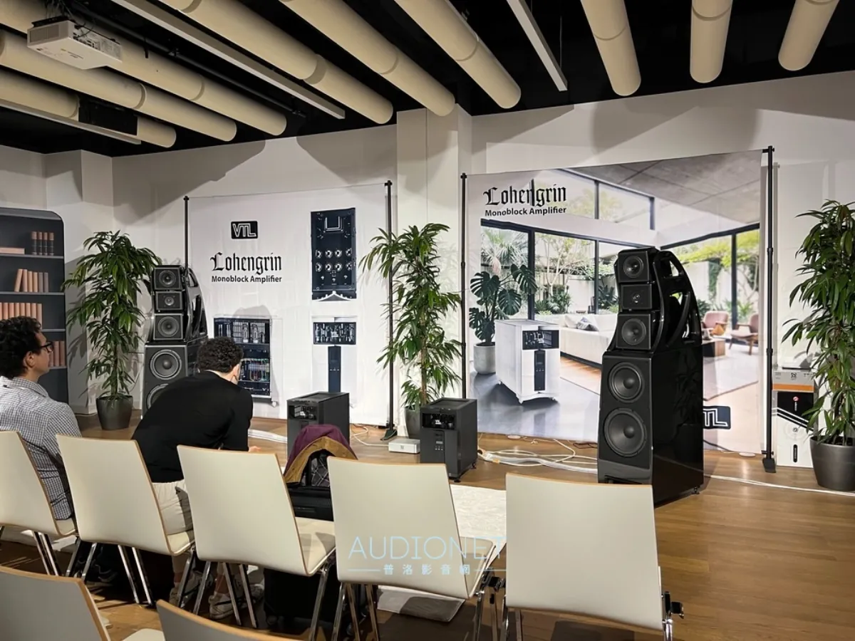 VTL's listening room at High End Vienna 2026, with attendees seated facing Lohengrin monoblock amplifiers and speakers against printed backdrop posters